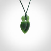 This picture shows a stylised couple in a close embrace sharing a kiss. The pendant is hand carved from a bright faultless piece of British Columbian jade. The cord is a 3-ply plaited green which is adjustable.